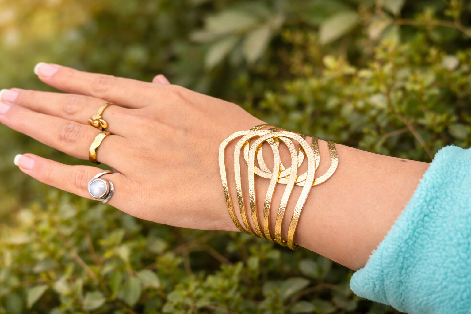 “Golden textured alloy adjustable cuff bracelet worn on wrist modern statement bracelet for women”