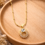 Shop elegant gold-plated pendant necklace with a sparkling crystal and halo baguette design. Perfect for daily wear, gifting, and special occasions.
