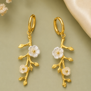 Gold floral branch drop earrings with delicate white flower accents for women.
