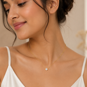 Minimalist gold-toned necklace featuring a sparkling solitaire crystal pendant on a delicate chain.